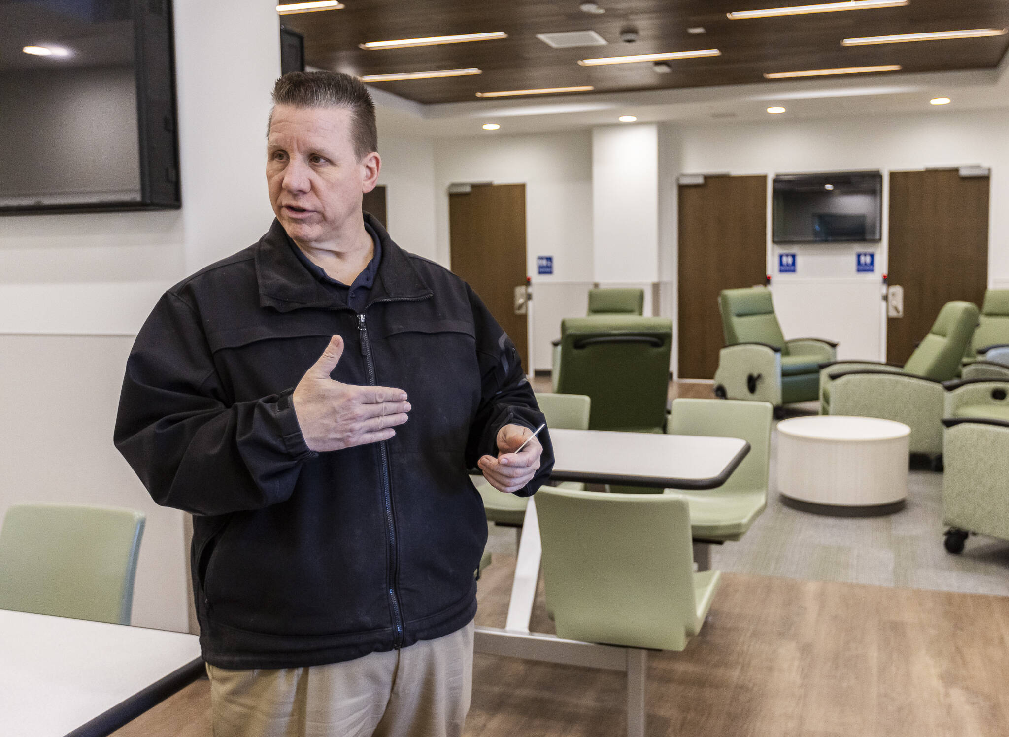 Chuck Steichen, project manager and Lynnwood deputy chief of police, talks about the first floor space of the Lynnwood Crisis Care Center on Friday, Feb. 7, 2025, in Lynnwood, Washington. (Olivia Vanni / The Herald)