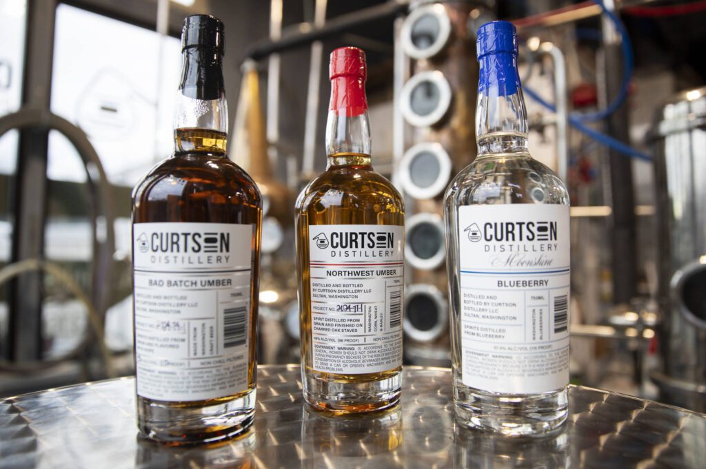 Curtson Distillery’s Bad Batch Umber, Northwest Umber and Blueberry Moonshine. (Olivia Vanni / The Herald)
