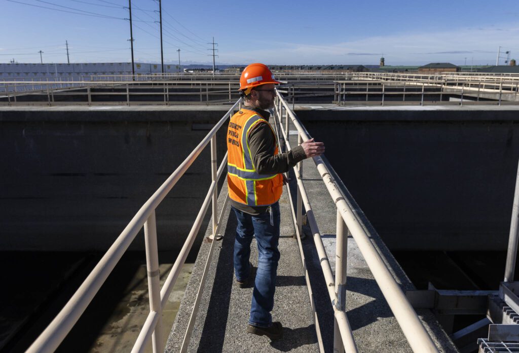 City of Everett Principal Engineer Zach Brown walks past the water storage tanks at the Port Gardner Storage Facility on Thursday, Feb. 27, 2025 in Everett, Washington. (Olivia Vanni / The Herald)
