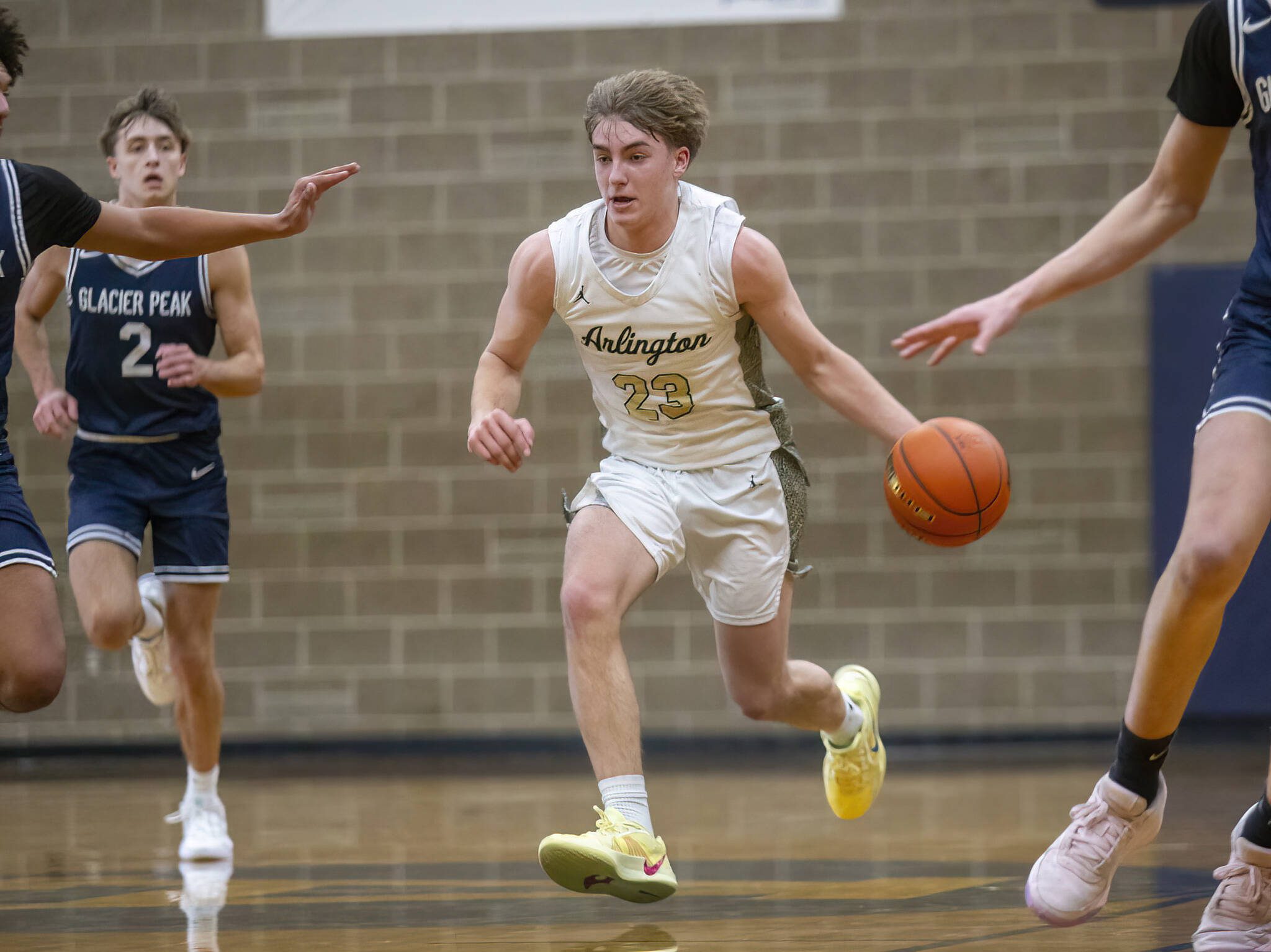 Arlington’s Leyton Martin takes the ball down the court during the game against Glacier Peak on Friday, Jan. 17, 2025 in Arlington, Washington. (Olivia Vanni / The Herald)