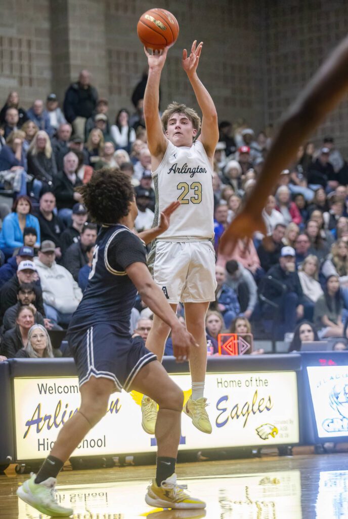 Arlington’s Leyton Martin makes a three point shot during the game against Glacier peakon Friday, Jan. 17, 2025 in Arlington, Washington. (Olivia Vanni / The Herald)
