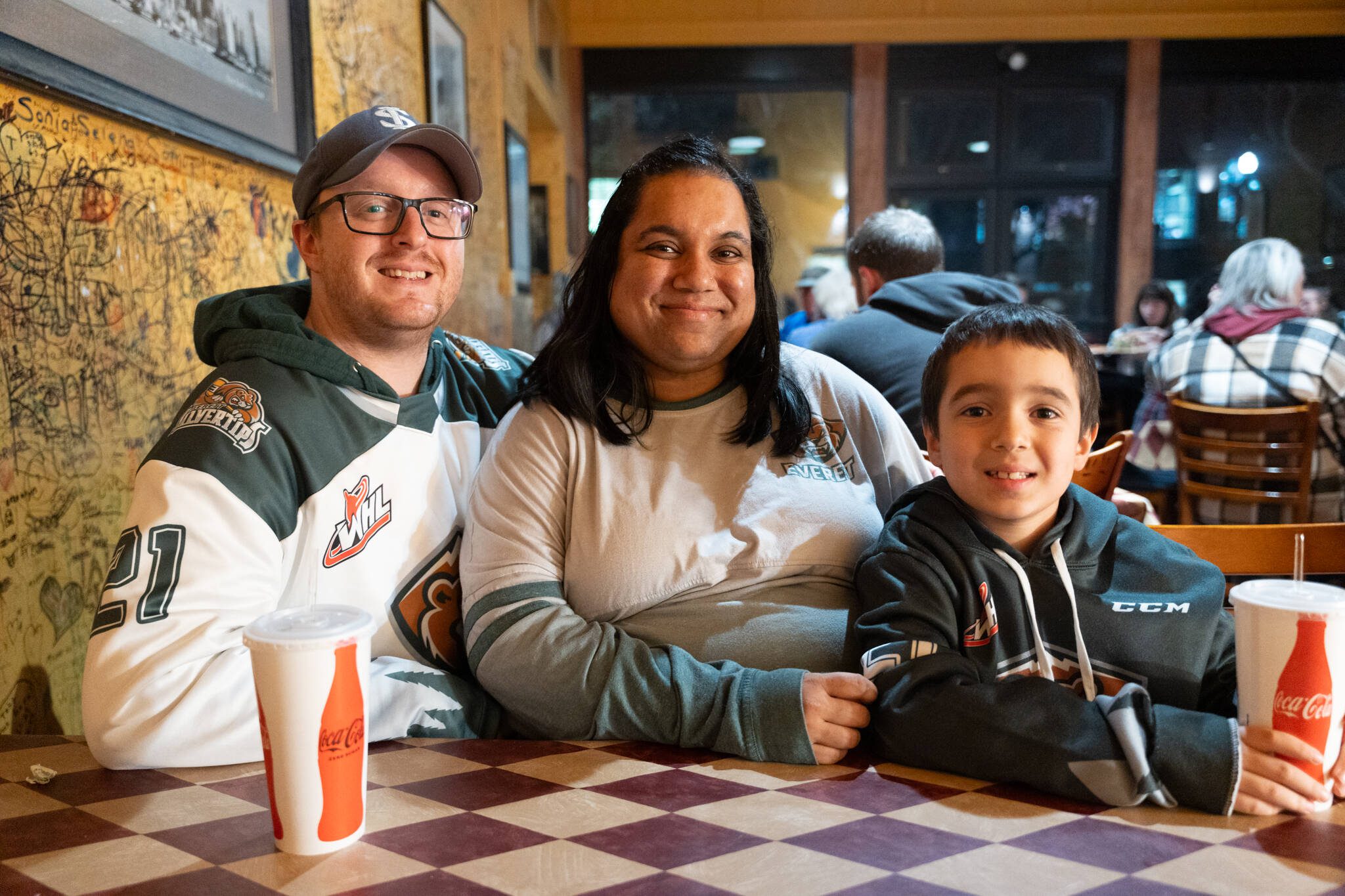 From left, Eric, Riddhi, and 8-year-old Ajay Blow on Jan. 17 at Brooklyn Bros. Pizza in Everett, Washington. (Will Geschke / The Herald)