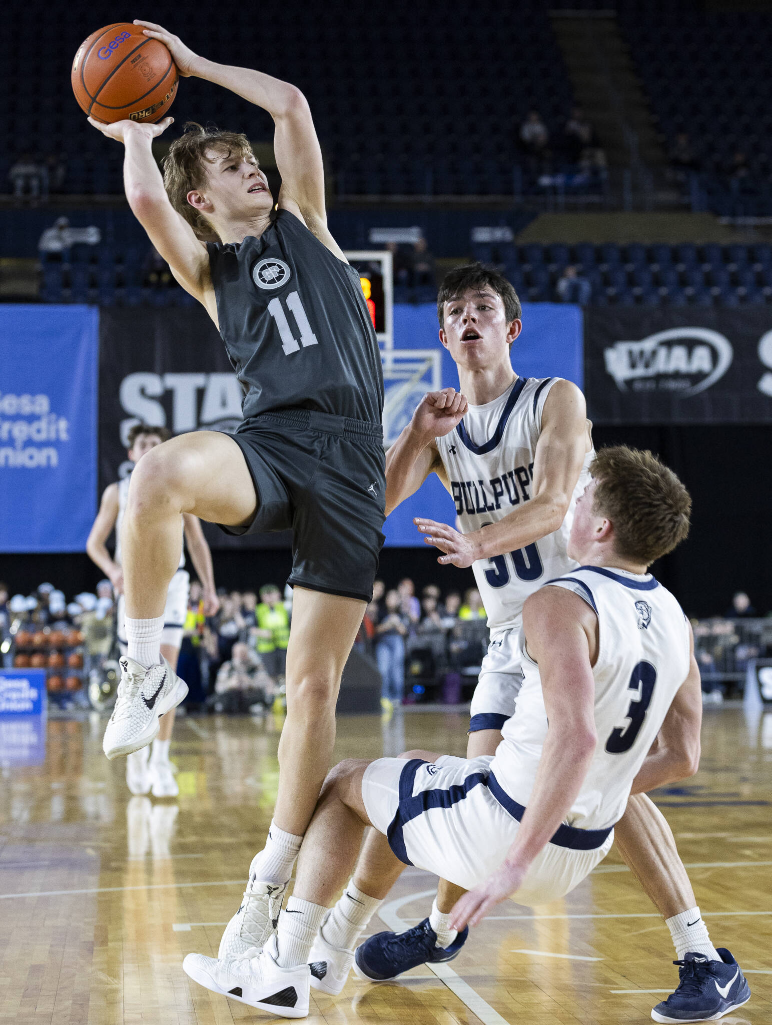 Glacier Peak’s Reed Nagel runs into Gonzaga Prep’s Hudson Floyd while trying to make a jump shot during the 4A boys semifinal game on Friday, March 7, 2025 in Tacoma, Washington. (Olivia Vanni / The Herald)