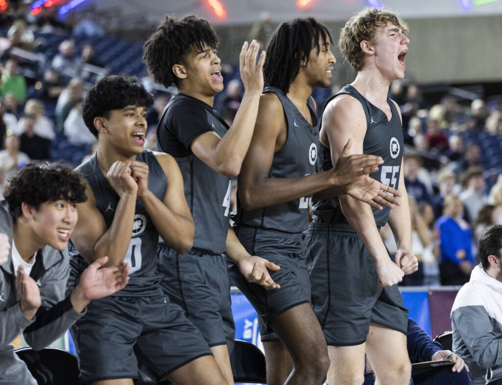 The Glacier Peak bench reacts to a teammate drawing a foul during the 4A boys semifinal game against Gonzaga Prep on Friday, March 7, 2025 in Tacoma, Washington. (Olivia Vanni / The Herald)
