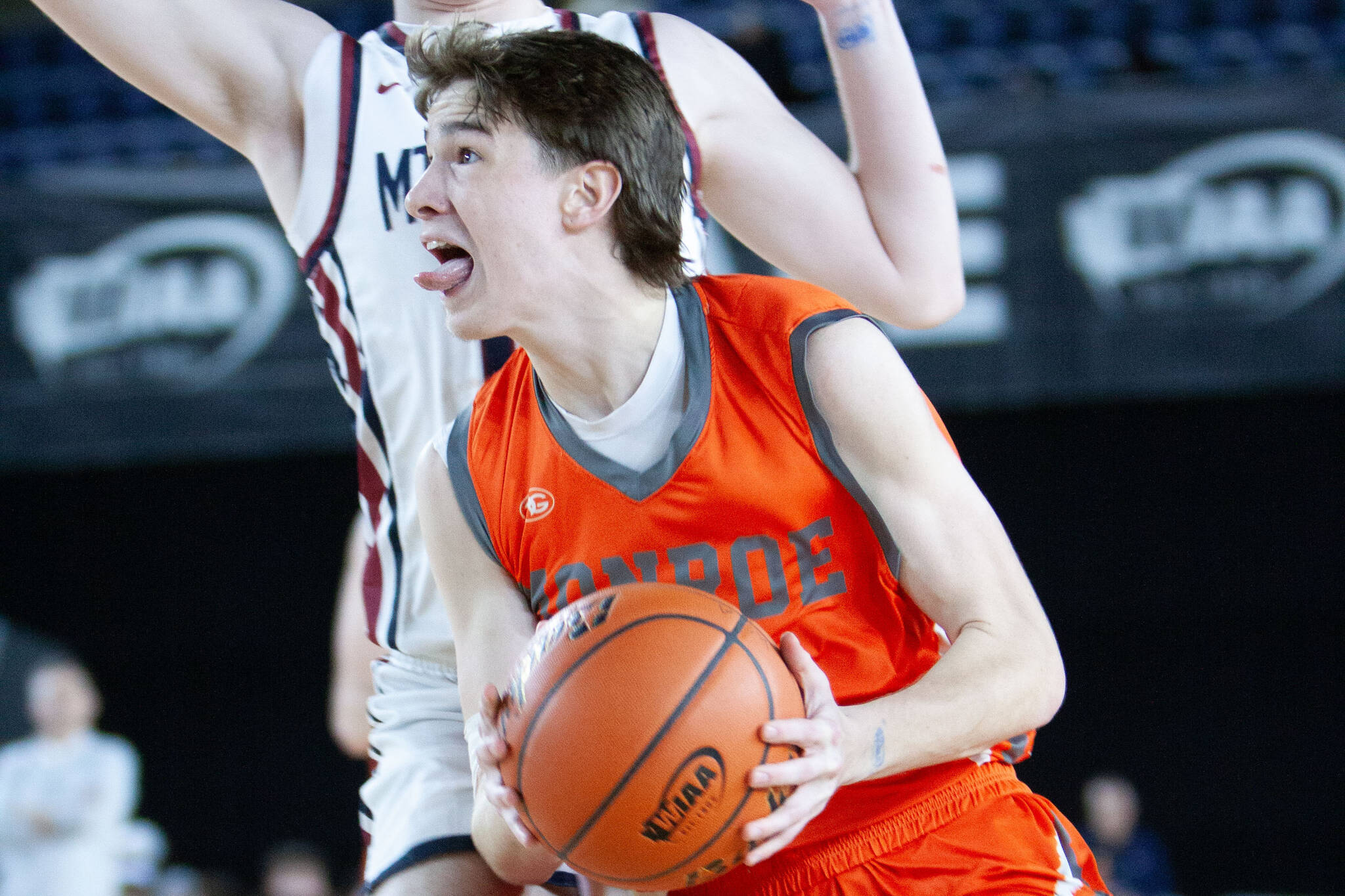 Monroe's Isaiah Kiehl fights through contact for a layup during a March 5, 2025 state playoff game against Mt. Spokane at the Tacoma Dome. (Qasim Ali / The Herald)