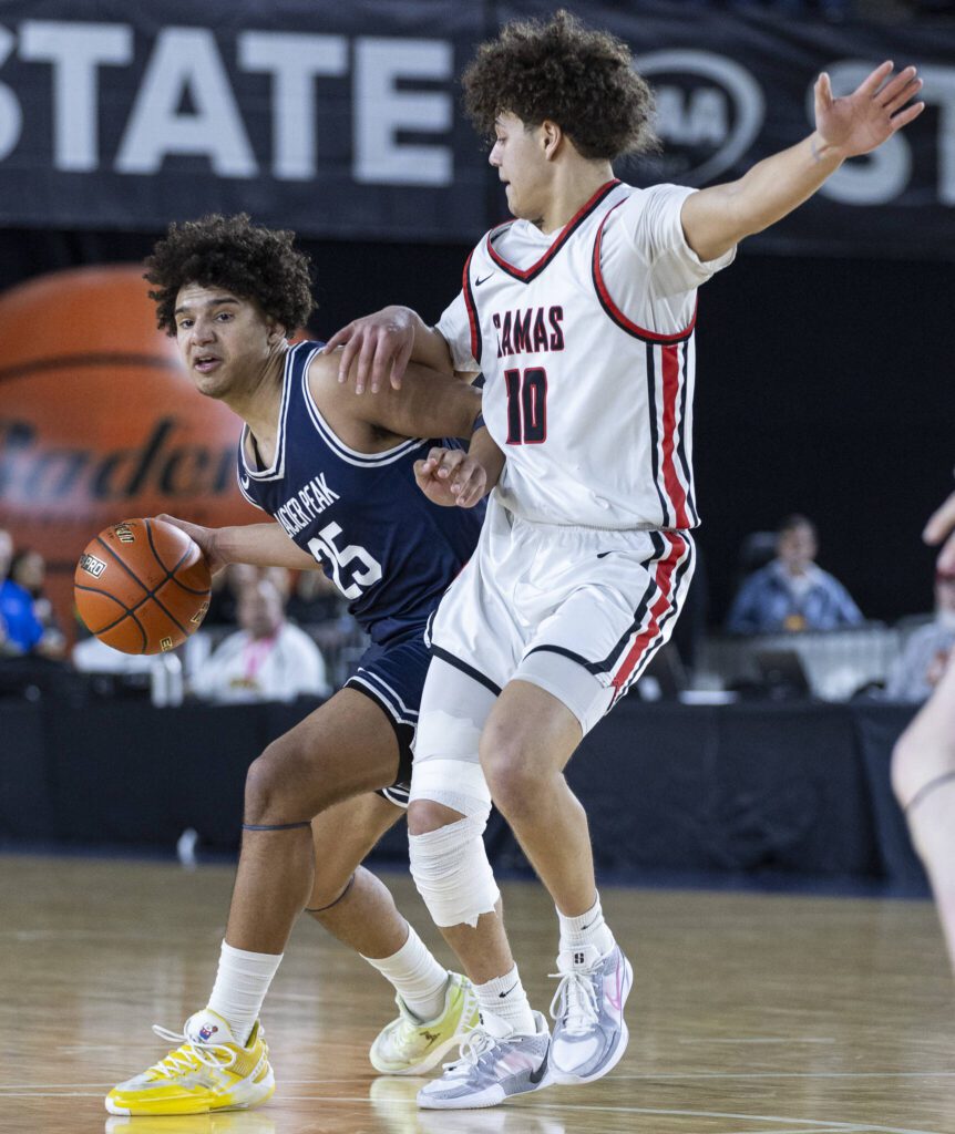 Glacier Peak’s Jayce Nelson tries to dribble around Camas’ Cade Washington during the 4A boys quarterfinal game against Camas on Thursday, March 6, 2025 in Tacoma, Washington. (Olivia Vanni / The Herald)
