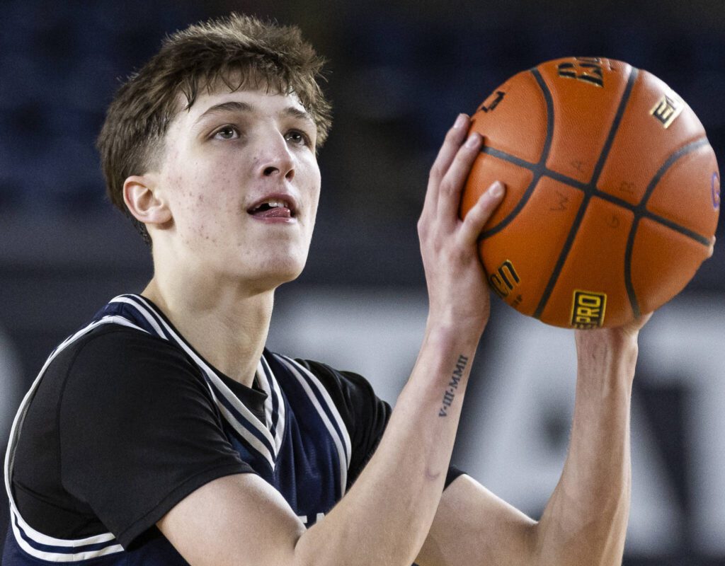Glacier Peak’s Jack Taylor sticks his tongue out next to his chipped tooth while making a free-throw during the 4A boys quarterfinal game against Camas on Thursday, March 6, 2025 in Tacoma, Washington. (Olivia Vanni / The Herald)
