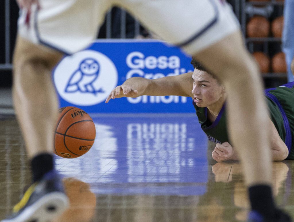 Edmonds-Woodway’s Julian Gray scrambles on the ground for a loose ball during the 3A boys semifinal game against Mt. Spokane on Friday, March 7, 2025 in Tacoma, Washington. (Olivia Vanni / The Herald)
