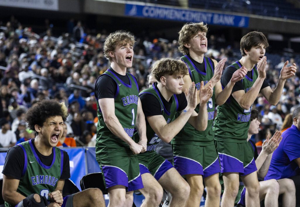 The Edmonds-Woodway bench reacts to a shot during the 3A boys championship game against Rainier Beach on Saturday, March 8, 2025 in Tacoma, Washington. (Olivia Vanni / The Herald)
