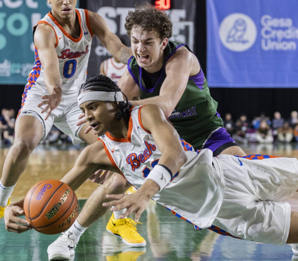 Edmonds-Woodway’s Cam Hiatt and Rainier Beach’s Micah Ili-Meneese scramble for a loose ball during the 3A boys championship game on Saturday, March 8, 2025 in Tacoma, Washington. (Olivia Vanni / The Herald)
