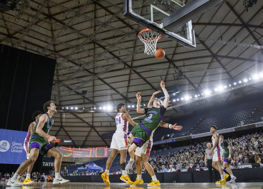 Edmonds-Woodway’s Grant Williams falls after attempting a layup during the 3A boys championship game against Rainier Beach on Saturday, March 8, 2025 in Tacoma, Washington. (Olivia Vanni / The Herald)
