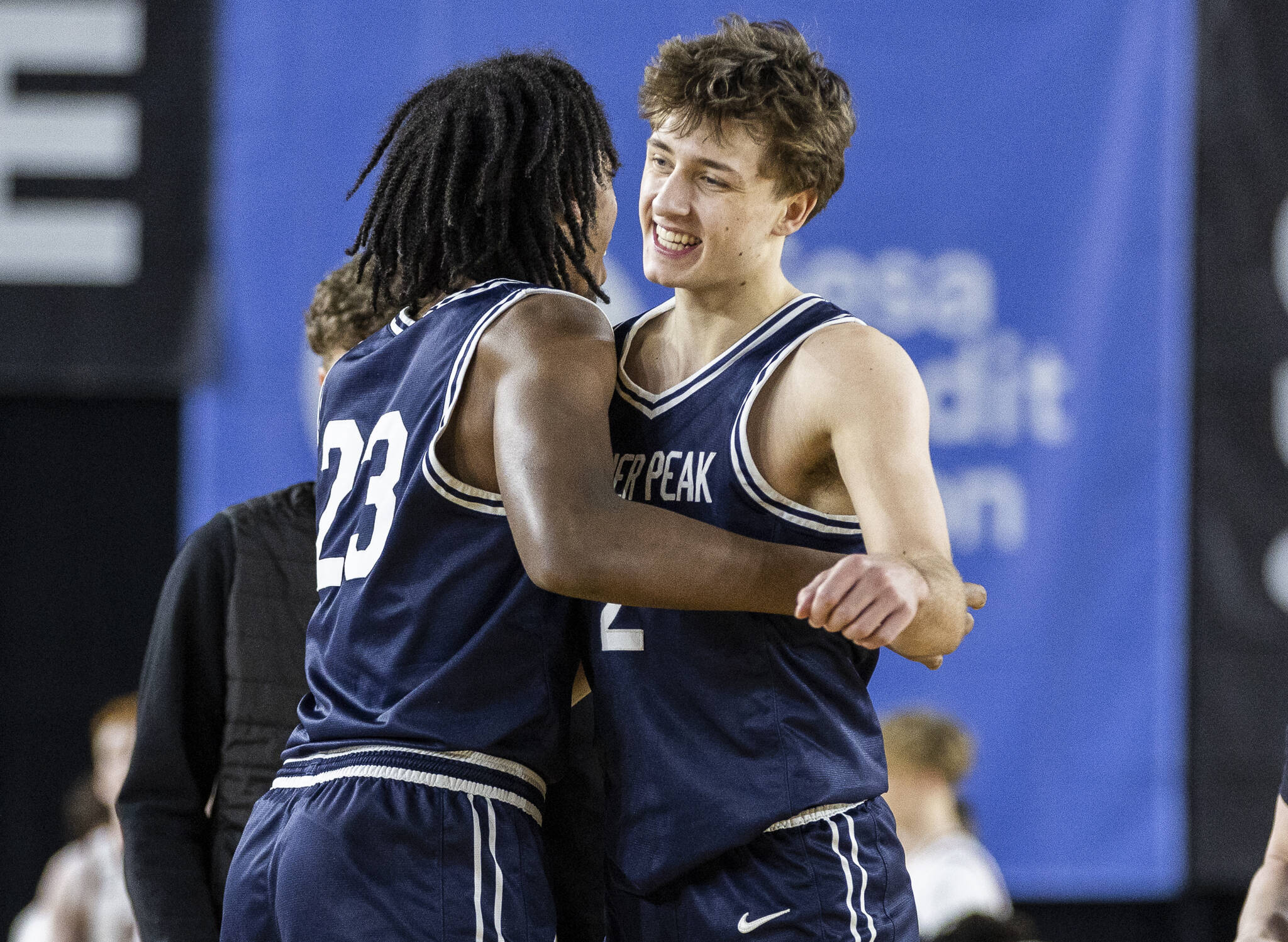 Glacier Peak’s Jo Lee is hugged by his teammate Paulos Mulugeta after winning the 4A boys quarterfinal game against Camas on Thursday, March 6, 2025 in Tacoma, Washington. (Olivia Vanni / The Herald)