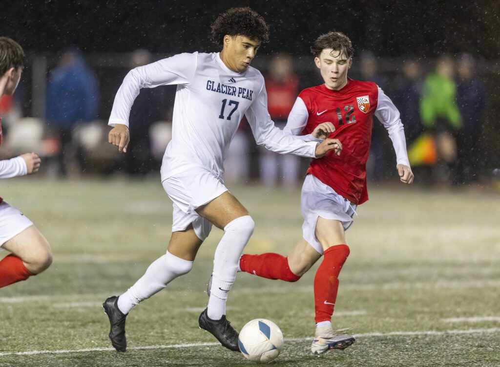 Glacier Peak’s Joziah Coppin dribbles the ball down the field during the game against Snohomish on Wednesday, March 12, 2025 in Snohomish, Washington. (Olivia Vanni / The Herald)
