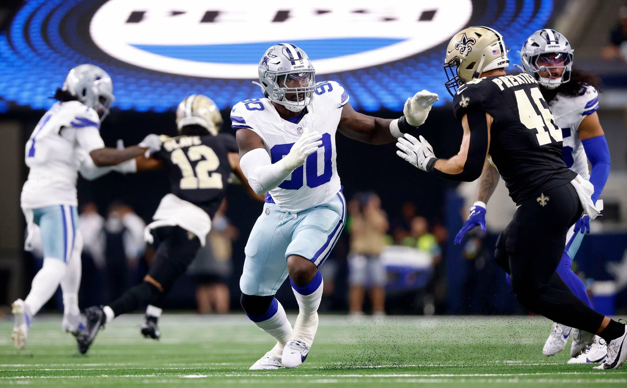 Dallas Cowboys defensive end DeMarcus Lawrence (90) looks to get around New Orleans Saints fullback Adam Prentice (46) as the play starts coming his way during the first half at AT&T Stadium in Arlington, September 15, 2024. (Tom Fox / Tribune News Services)