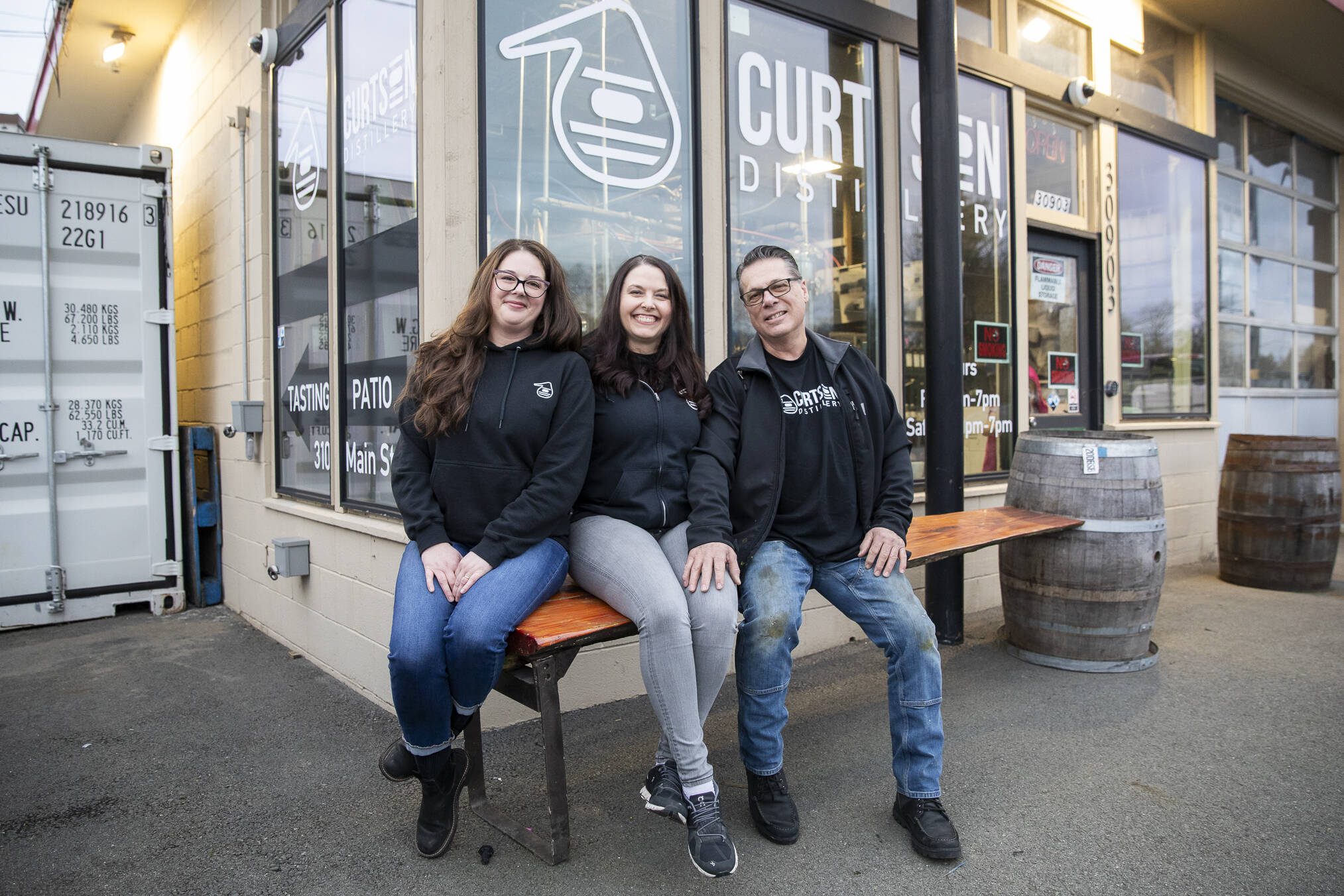 Curtson Distillery owners Robert Thompson, right, Malinda Curtis, center, and employee Sarah Trocano, left, at the distillery in Sultan. (Olivia Vanni / The Herald)