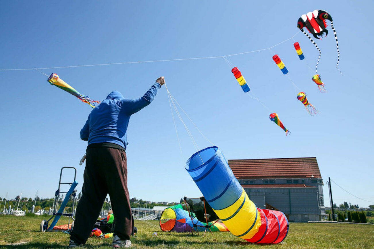David Ngle works to attach another kite at Boxcar Park in Everett in 2020. Tuesday could see the first 67 degree day in the Everett area. (Kevin Clark / The Herald)