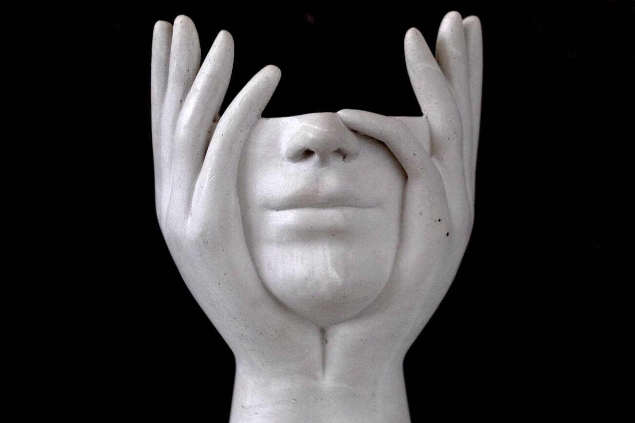 on a black background - a white plaster figurine without a head with a sense of thoughtfulness. High quality photo