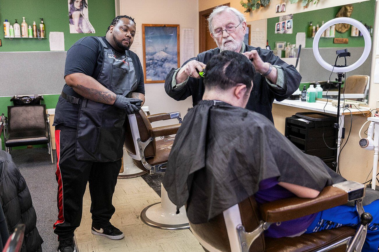 Don Sharrett talks John Wrice through his trimming technique on Friday, March 14, 2025 in Everett, Washington. (Olivia Vanni / The Herald)
