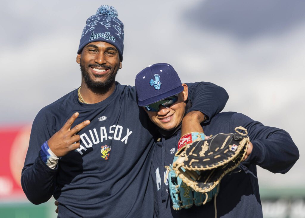 AquaSox’s Lazaro Montes and Milkar Perez smile and laugh for a photo during a break at practice at Funko Field on Tuesday, April 1, 2025 in Everett, Washington. (Olivia Vanni / The Herald)
