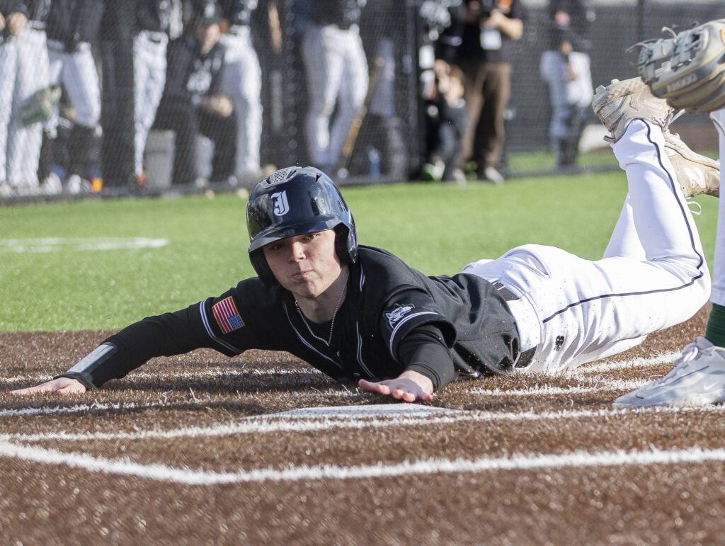 Jackson’s MJ Holcomb slides into home to score during the game against Edmonds-Woodway on Wednesday, April 2, 2025 in Edmonds, Washington. (Olivia Vanni / The Herald)
