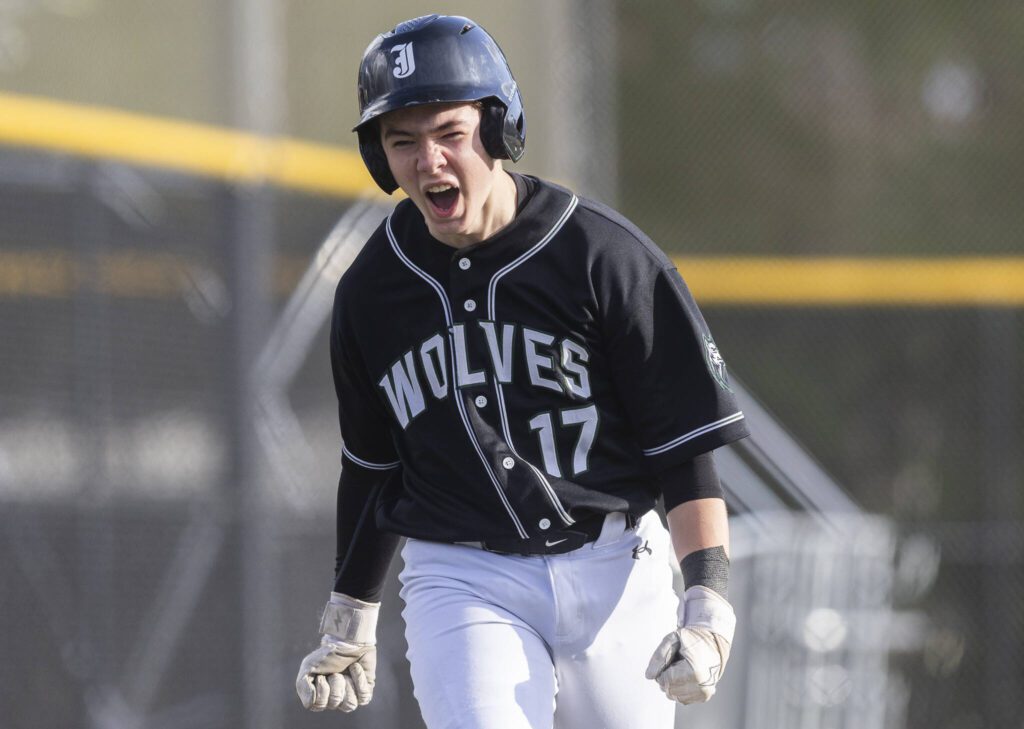 Jackson’s Gavin Duckart yells as he makes his way toward home plate after being hit in by a homer from his teammate Sam Craig during the game against Edmonds-Woodway on Wednesday, April 2, 2025 in Edmonds, Washington. (Olivia Vanni / The Herald)
