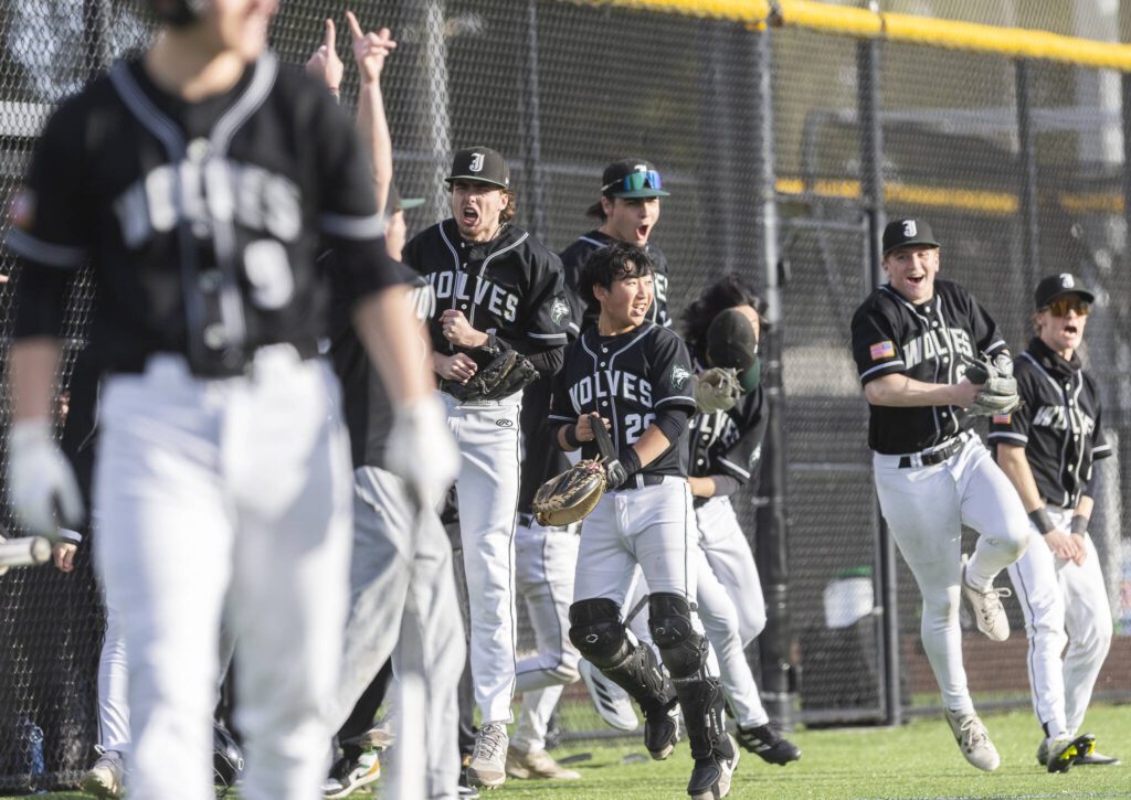 The Jackson dugout clears in celebration of their teammate Sam Craig’s home run to put them ahead of Edmonds-Woodway during the game on Wednesday, April 2, 2025 in Edmonds, Washington. (Olivia Vanni / The Herald)
