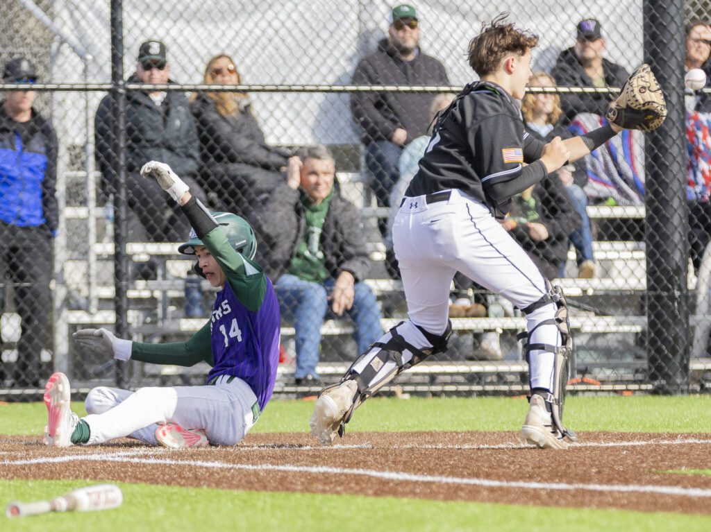 Edmonds-Woodway’s Toshi Gilginas slides into home to score during the game against Jackson on Wednesday, April 2, 2025 in Edmonds, Washington. (Olivia Vanni / The Herald)
