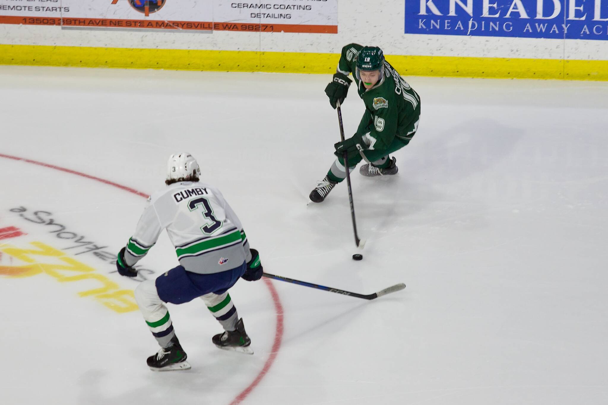 Everett Silvertips forward Nolan Chastko challenges Seattle Thunderbirds defenseman Ashton Cumby in Everett's 3-2  overtime win against Seattle in Game 2 of the WHL Playoffs First Round at Angel of the Winds Arena in Everett, Washington on March 29, 2025. (Joe Pohoryles / The Herald)