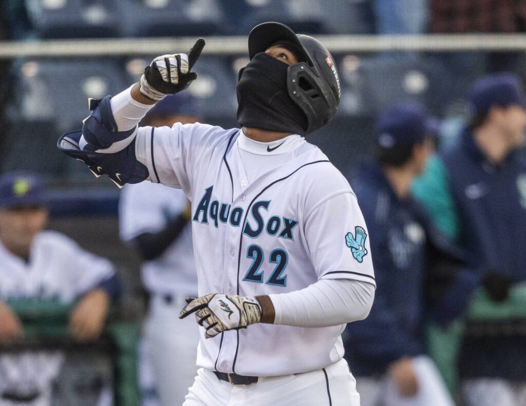 Everett AquaSox outfielder Lazaro Montes point up as he runs into home to score after hitting a home run during the Opening Day game against the Hillsboro Hops on Tuesday, April 8, 2025 in Everett, Washington. (Olivia Vanni / The Herald)
