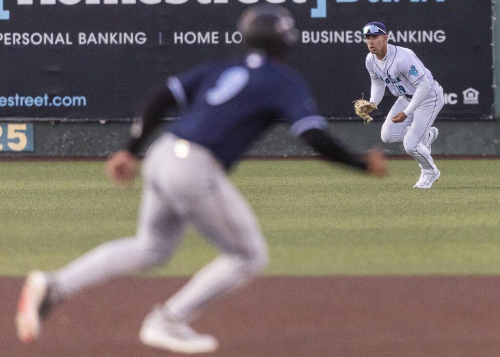 Everett AquaSox outfielder Carson Jones fields the ball and looks up to throw the ball in during the Opening Day game against the Hillsboro Hops on Tuesday, April 8, 2025 in Everett, Washington. (Olivia Vanni / The Herald)
