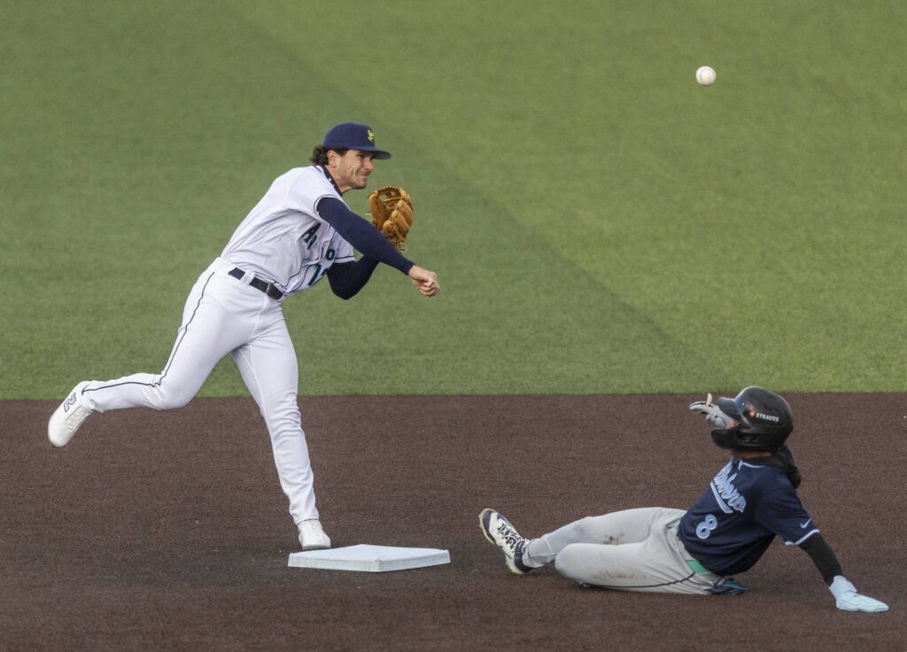 Everett AquaSox second baseman Charlie Pagliarini gets an out at second and throws the ball to first during the Opening Day game against the Hillsboro Hops on Tuesday, April 8, 2025 in Everett, Washington. (Olivia Vanni / The Herald)
