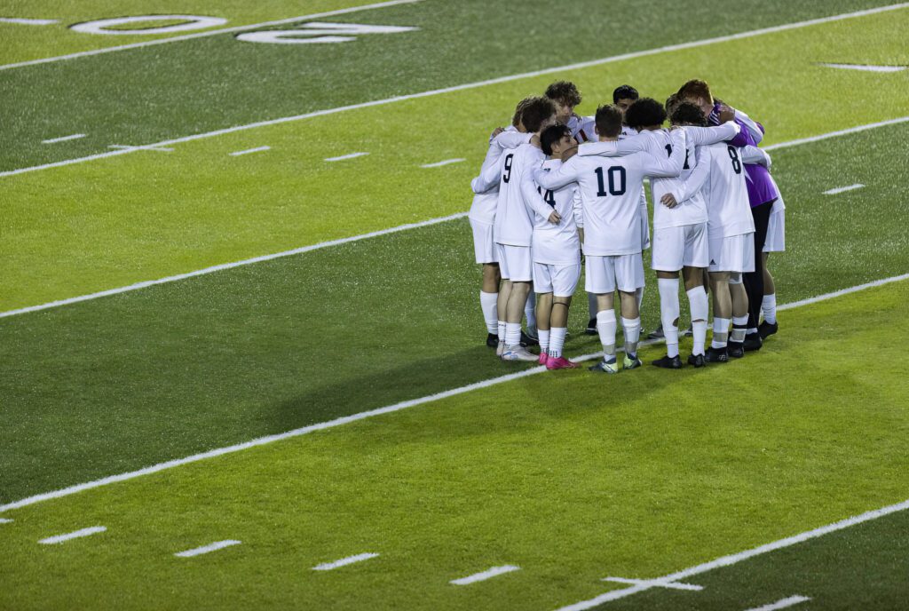 Glacier Peak players huddle on the field before the start of the second half during the game against Jackson on Tuesday, April 15, 2025 in Everett, Washington. (Olivia Vanni / The Herald)
