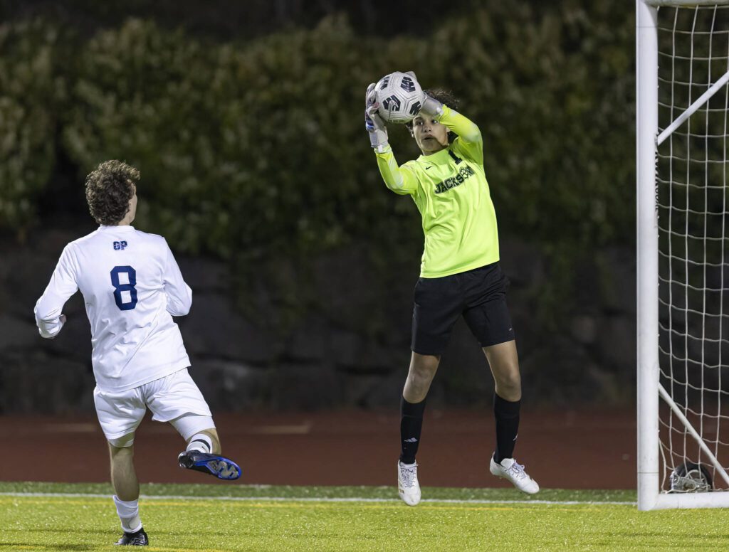 Jackson’s Karson Ghosh leaps in the air for a save during the game against Glacier Peak on Tuesday, April 15, 2025 in Everett, Washington. (Olivia Vanni / The Herald)
