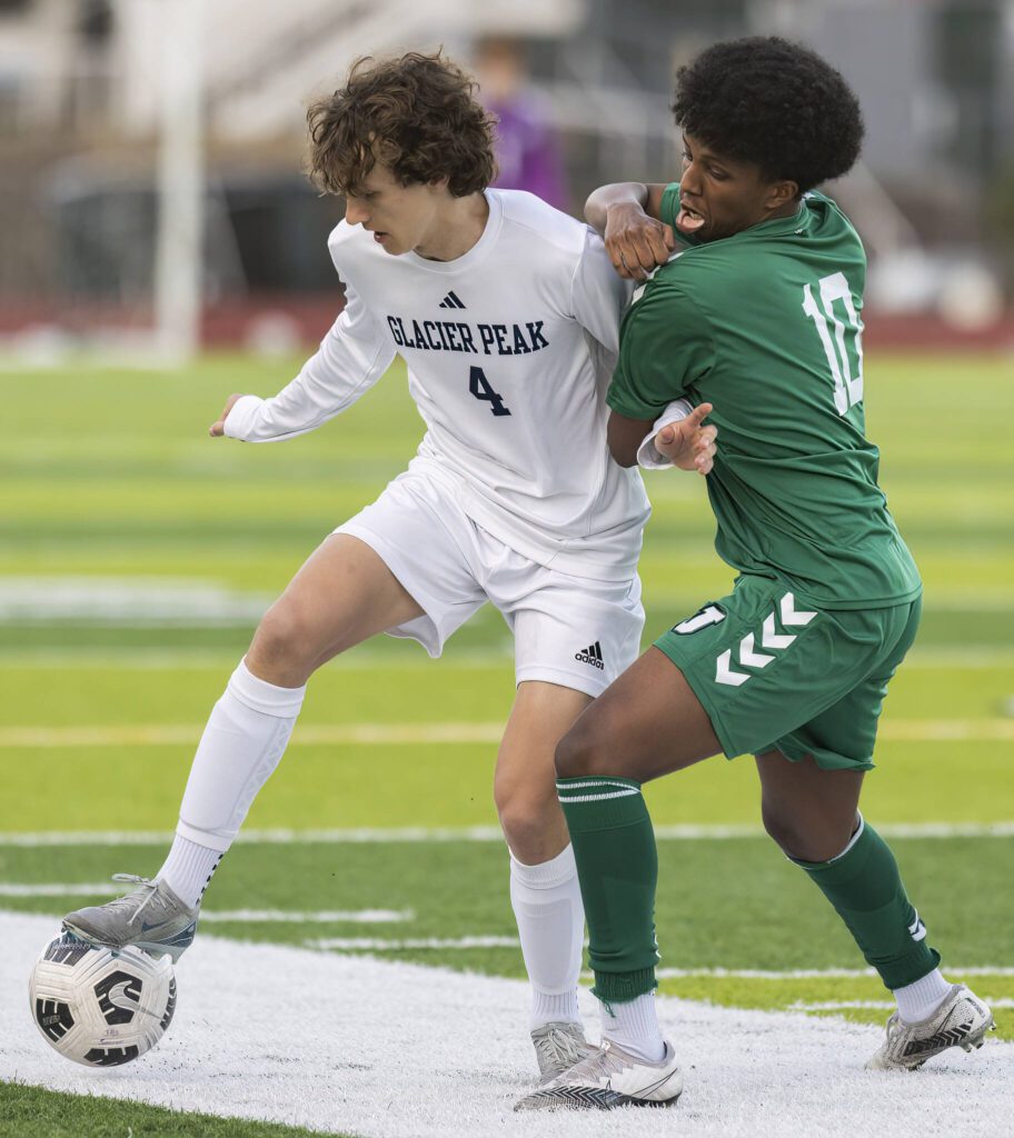 Glacier Peak’s Ethan Jewett tries to keep the ball away from Jackson’s Chris Abyot during the game on Tuesday, April 15, 2025 in Everett, Washington. (Olivia Vanni / The Herald)
