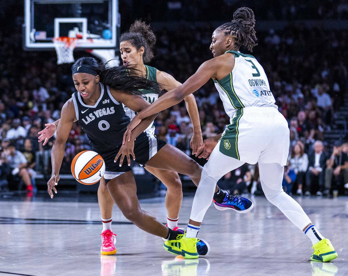 Aces guard Jackie Young (0) is fouled by Seattle Storm forward Nneka Ogwumike (3) with guard Skylar Diggins-Smith (4) on a double team during the first half of their WNBA playoffs game 2 at Michelob Ultra Arena on Tuesday, Sept. 24, 2024, in Las Vegas. (L.E. Baskow / Las Vegas Review-Journal / Tribune Content Services)