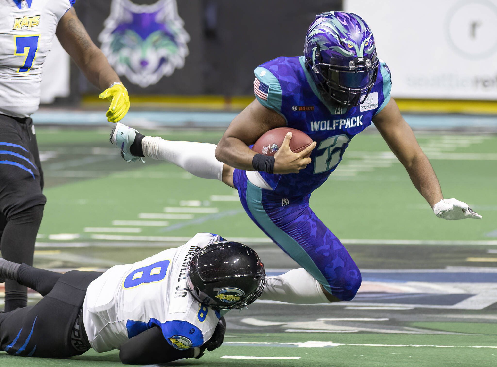 Washington Wolfpack’s Ed Crouch Jr. leaps to try and escape a tackle by Nashville Kats’ Derrick Maxwell Jr during the game on Thursday, April 17, 2025 in Everett, Washington. (Olivia Vanni / The Herald)