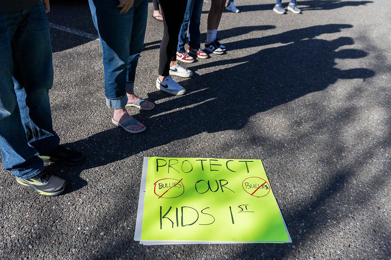 Over a dozen parents and some Snohomish School District students gather outside of the district office to protest and discuss safety concerns after an incident with a student at Machias Elementary School on Friday, April 18, 2025 in Snohomish, Washington. (Olivia Vanni / The Herald)