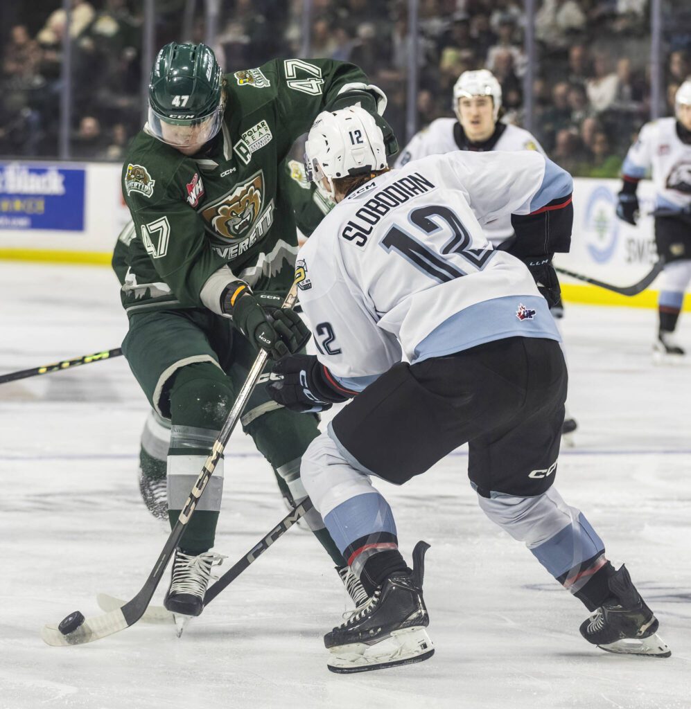 Everett Silvertips’ defenseman Kaden Hammell fights Portland Winterhawk’s Cole Slobodian for the puck during game seven of the second round of the WHL playoffs on Tuesday, April 22, 2025 in Everett, Washington. (Olivia Vanni / The Herald)
