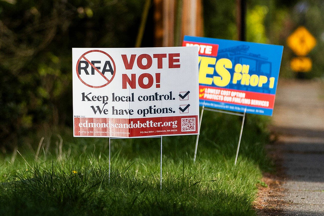 Signs in support of and opposition of the Proposition 1 annexation into RFA are visible along 100th Avenue West on Thursday, April 3, 2025 in Edmonds, Washington. (Olivia Vanni / The Herald)