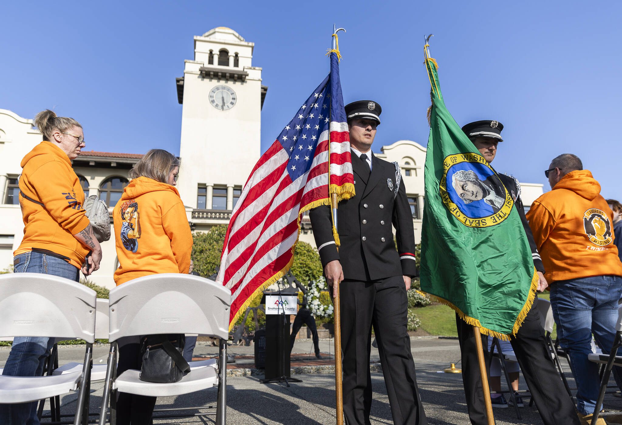 Everett Fire Department’s color guard Jozef Mendoza, left, and Grady Persons, right, parade the colors at the end of the ceremony on Worker’s Memorial Day on Wednesday, April 23, 2025 in Everett, Washington. (Olivia Vanni / The Herald)