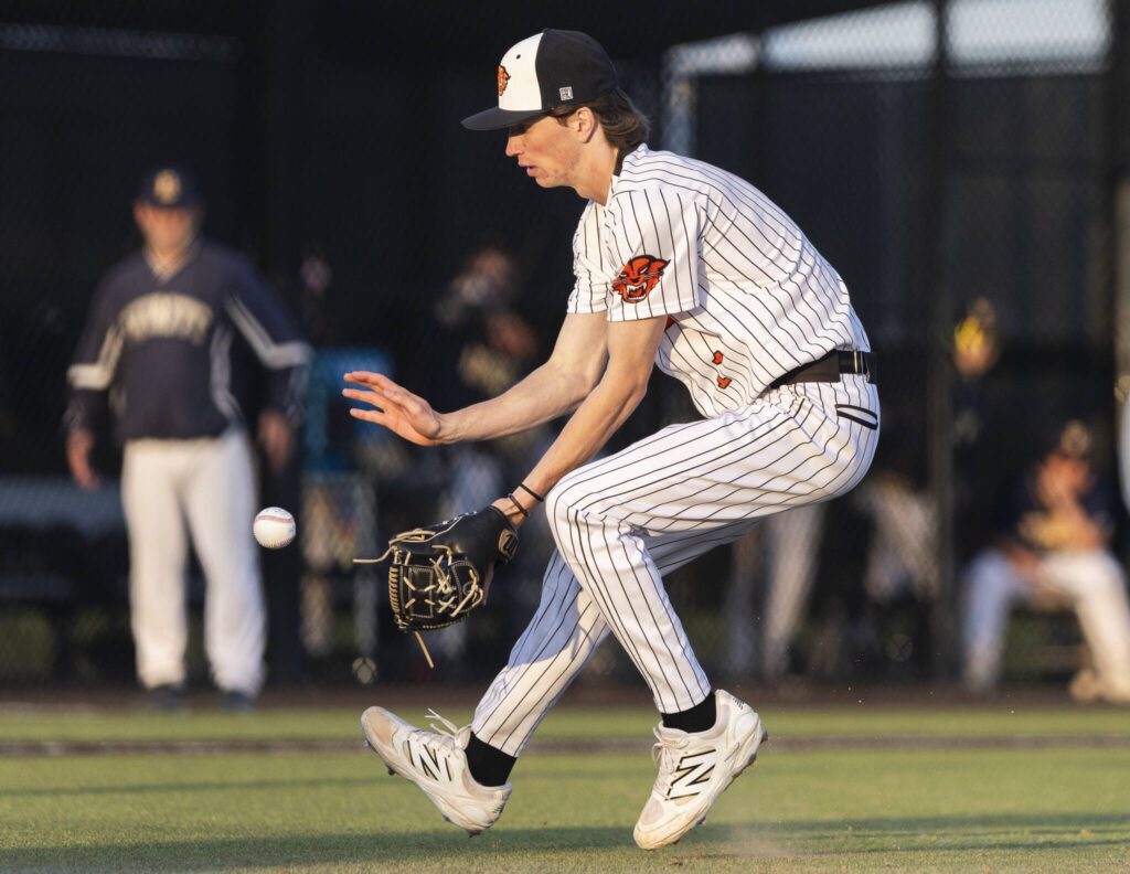 Monroe’s Caleb Campbell runs up to grab a bunt during the game against Everett on Wednesday, April 23, 2025 in Monroe, Washington. (Olivia Vanni / The Herald)
