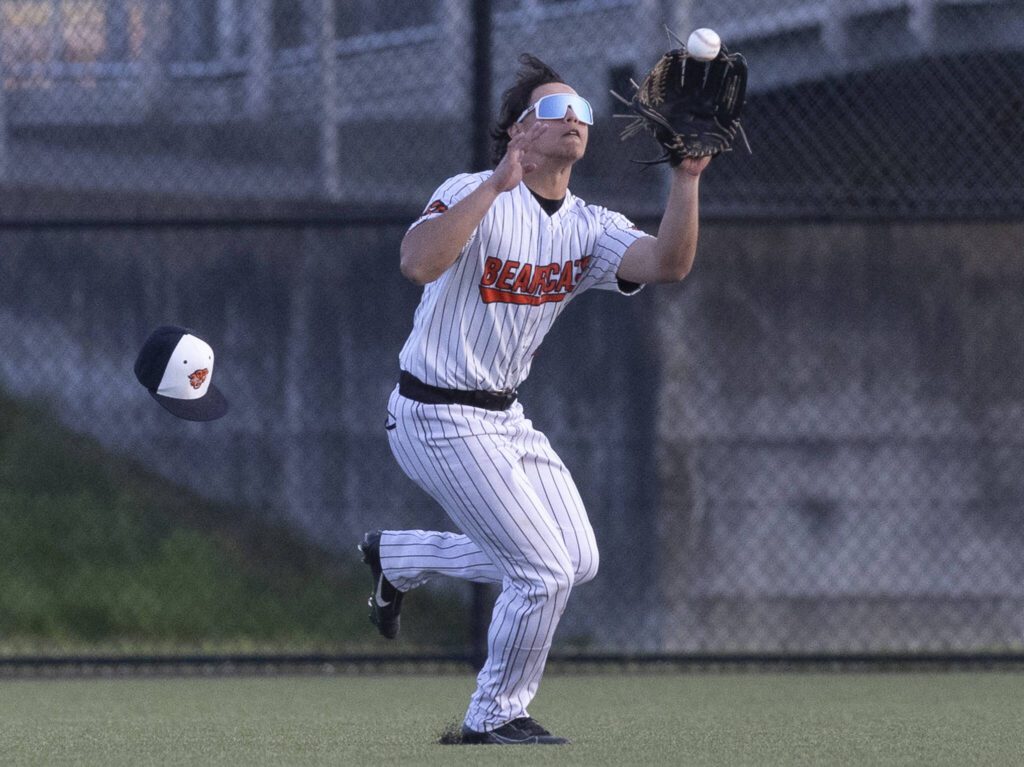 Monroe’s BK Kingsley loses his hat as he runs after the ball to make a catch in the outfield during the game against Everett on Wednesday, April 23, 2025 in Monroe, Washington. (Olivia Vanni / The Herald)
