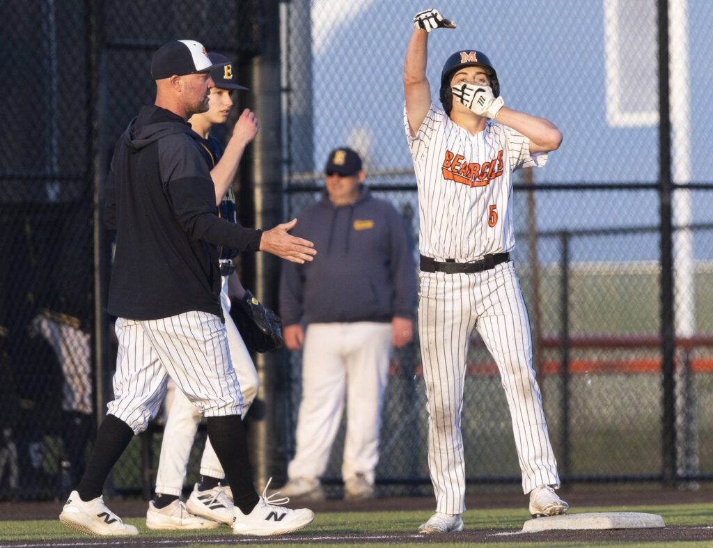 Monroe’s Braden Bingham celebrates after making it to third base during the game against Everett on Wednesday, April 23, 2025 in Monroe, Washington. (Olivia Vanni / The Herald)
