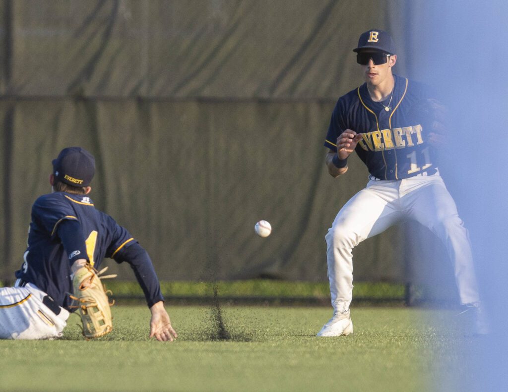 Everett’s Andreas Gutierrez backs up his teammate Jack Franklin after he overshoots a catch in the outfield during the game against Monroe on Wednesday, April 23, 2025 in Monroe, Washington. (Olivia Vanni / The Herald)
