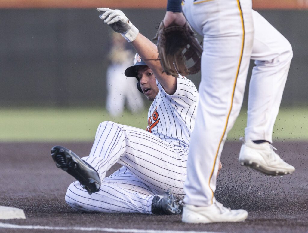 Monroe’s Brendon Kingsley slides into third base during the game against Everett on Wednesday, April 23, 2025 in Monroe, Washington. (Olivia Vanni / The Herald)

