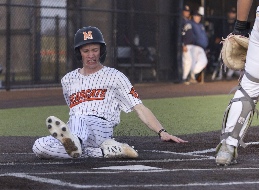 Monroe’s Caleb Campbell slides into home to score during the game against Everett on Wednesday, April 23, 2025 in Monroe, Washington. (Olivia Vanni / The Herald)
