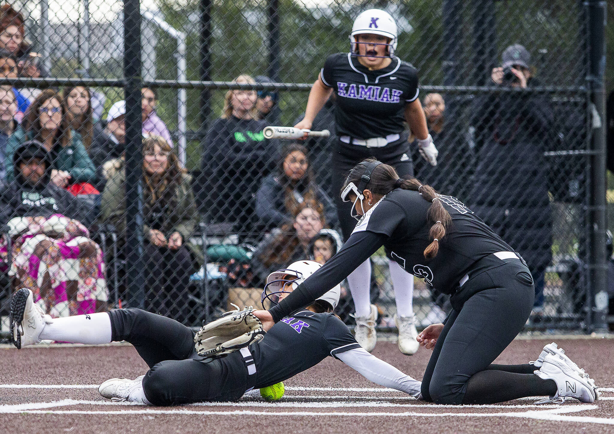 Kamiak’s Emma Stansfield slides into home to score after the ball misses the glove of Jackson’s Yanina Sherwood during the 4A district championship on Friday, May 17, 2024 in Everett, Washington. (Olivia Vanni / The Herald)