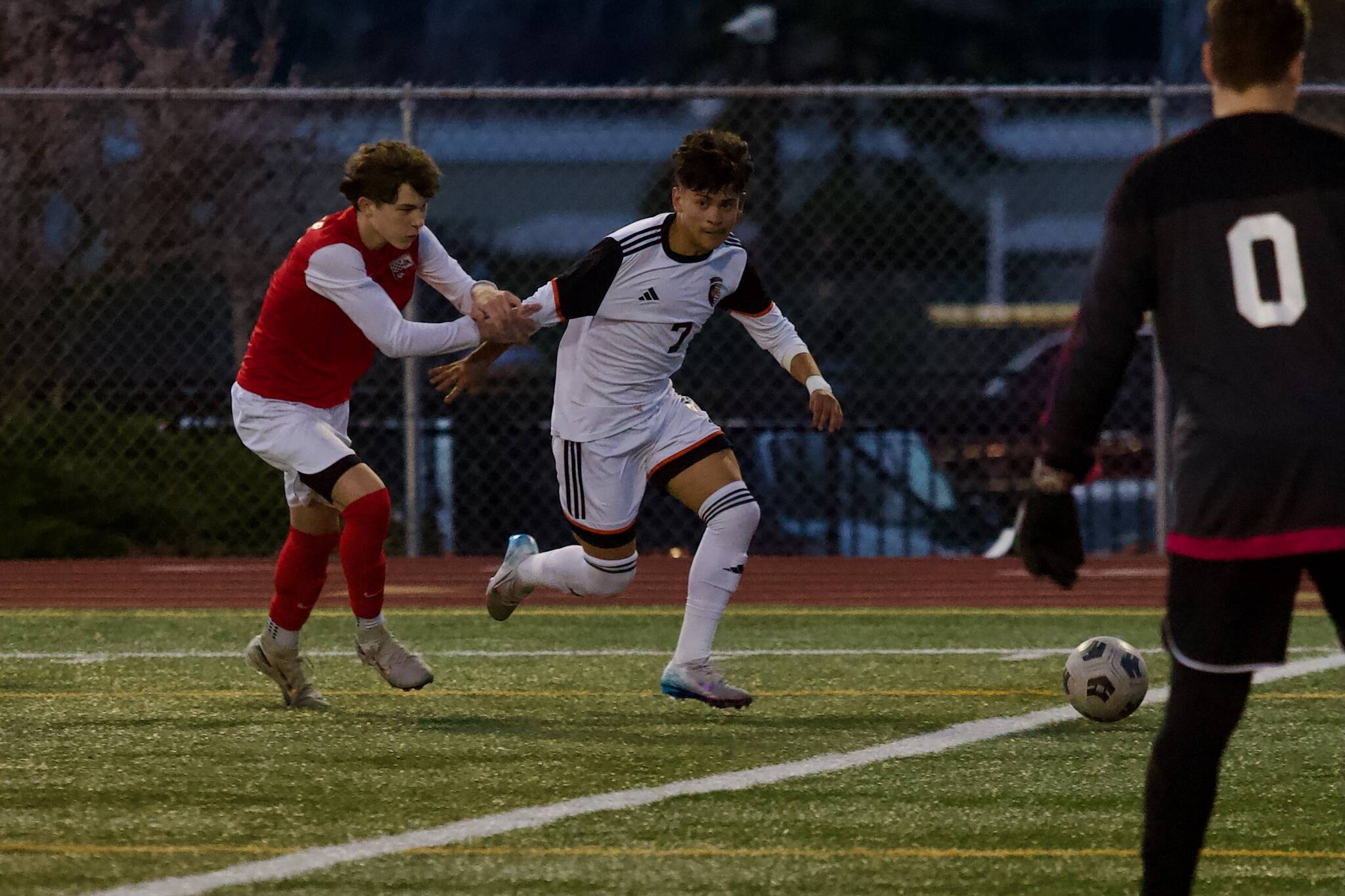 Monroe junior Julian Perez slips past a Snohomish defender before assisting the opening goal of the Bearcats’ 4-1 win at Veterans Memorial Stadium in Snohomish, Washington on April 4, 2025. (Joe Pohoryles / The Herald)