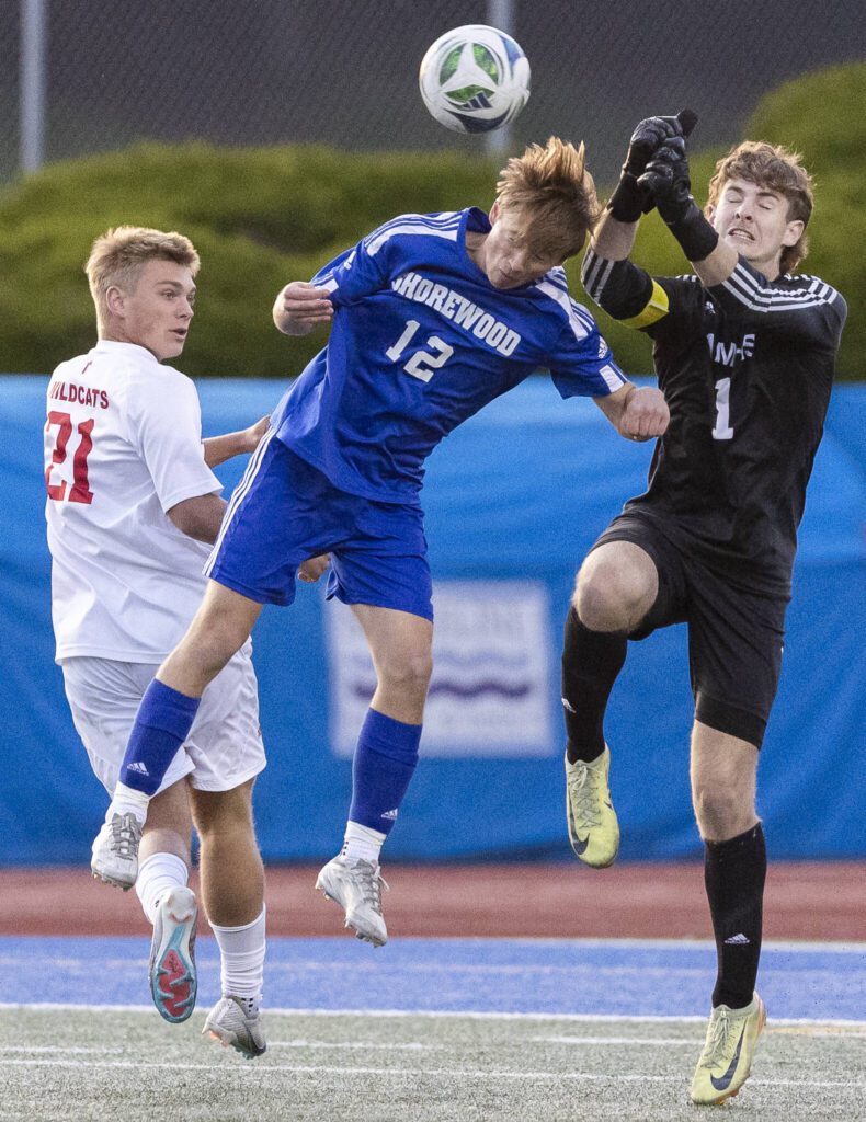 Shorewood’s Bobby Lamb and Archbishop Murphy’s Cameron Ilgenfritz leap in the air for the ball and collide during the game on Wednesday, April 30, 2025 in Shoreline, Washington. (Olivia Vanni / The Herald)
