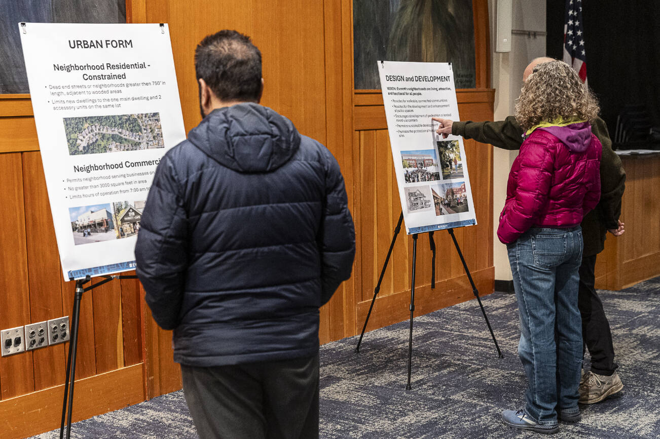People look over information boards on the Everett 2044 Comprehensive Plan update at the Everett Planning Department open house at Everett Station on Feb. 26, 2025, in Everett, Washington. (Olivia Vanni / The Herald)